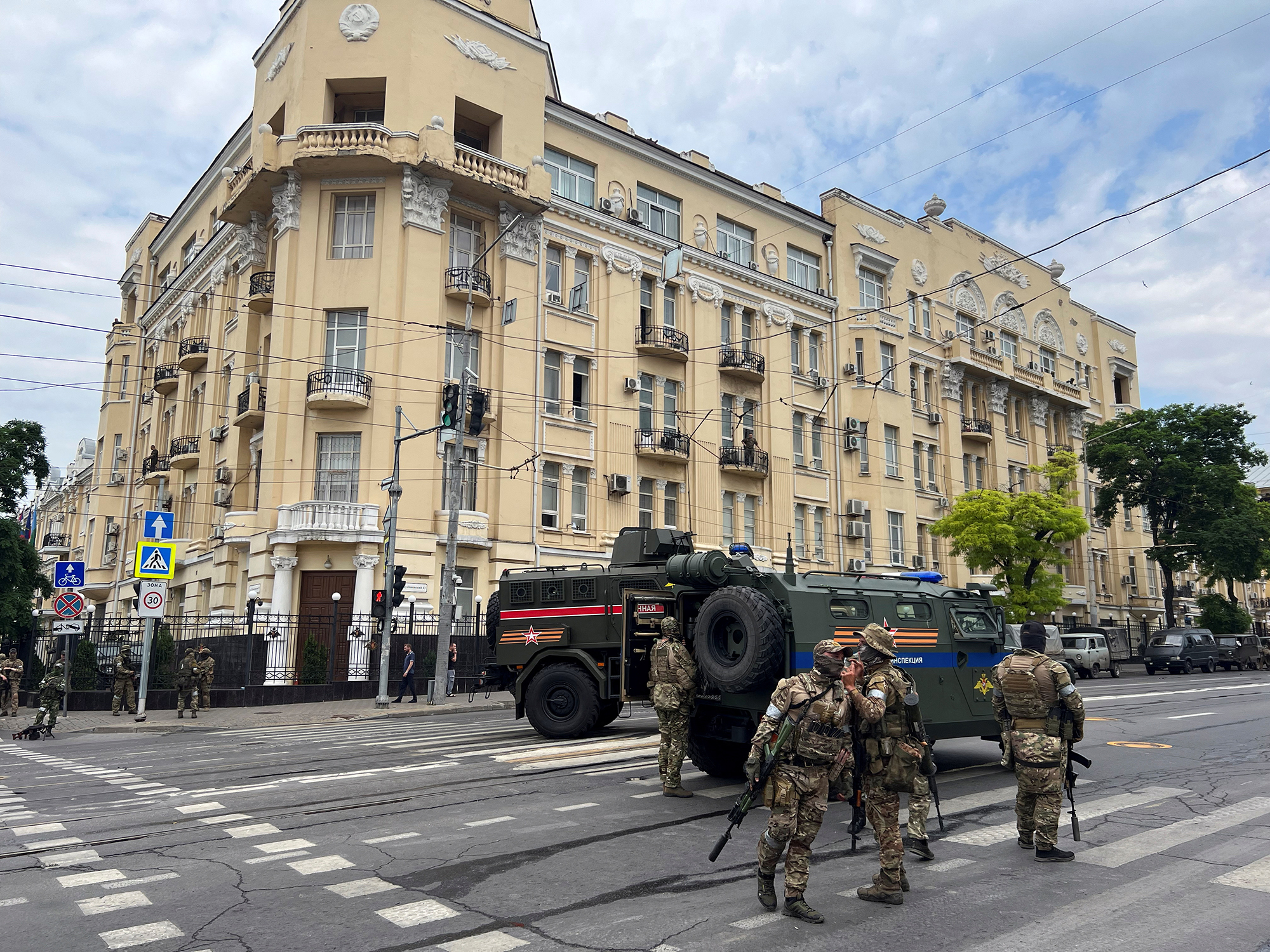 Fighters of Wagner private mercenary group stand guard in a street near the Southern Military Headquarters in Rostov-on-Don, Russia, on June 24. Stringer/Reuters